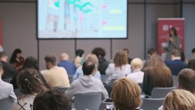 Group of people attending professional seminar with presenter speaking in front of a screen - Powered by Shutterstock - Get 15% off with code: PIKWIZARD15