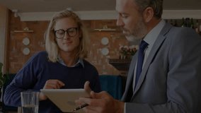 two colleagues placing tablet and animating financial data overlay on screen for stock analysis. Collaboration, finance, technology, data visualization, professional, workspace, analytical - Powered by Shutterstock - Get 15% off with code: PIKWIZARD15