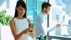 Co-workers scrolling smartphones by office window and spawning animated business engagement bubbles. Technology, connectivity, communication, digital, innovation, modern, networking - Powered by Shutterstock - Get 15% off with code: PIKWIZARD15