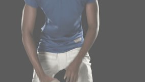 Football player crouching and receiving sports data on gray backdrop raising head adjusting helmet. Athlete, sports, technology, performance, focus, determination, futuristic - Powered by Shutterstock - Get 15% off with code: PIKWIZARD15