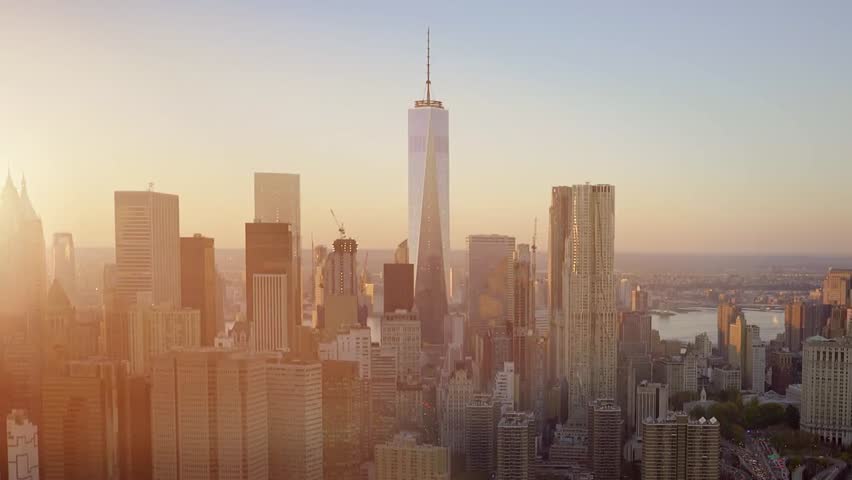 Wide establishing shot of New York City skyline featuring modern skyscrapers, showcasing the urban business district and iconic metropolitan landscape.
