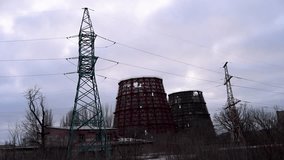 A power plant's cooling towers destroyed by a Russian missile strike in Kramatorsk, Ukraine. Dusk view of war-torn energy infrastructure on the Donbas frontline during the ongoing conflict. - Powered by Shutterstock - Get 15% off with code: PIKWIZARD15