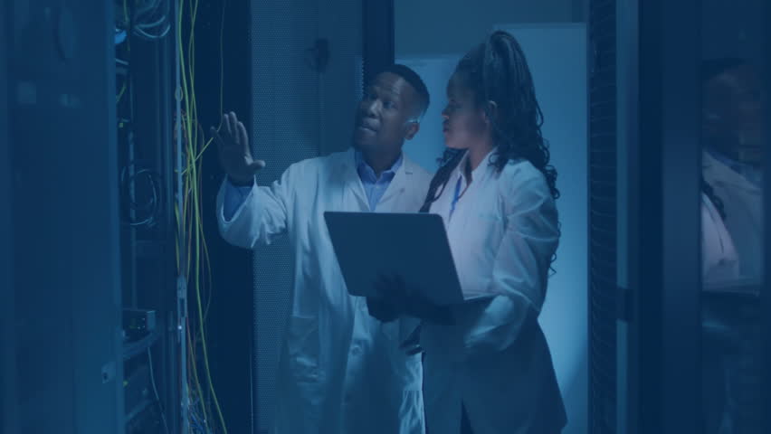 Technicians touching cables and typing on laptop, launching UI overlays showing server metrics. Technology, data, cybersecurity, interface, network, collaboration, innovation - Powered by Shutterstock - Get 15% off with code: PIKWIZARD15