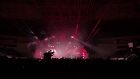 People enjoy a music concert. People on the dance floor applaud the concert and show of their favorite musical group. High quality 4k footage - Powered by Shutterstock - Get 15% off with code: PIKWIZARD15