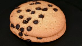 video of chocolate chip cookies on black background - Powered by Shutterstock - Get 15% off with code: PIKWIZARD15