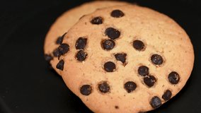 video of chocolate chip cookies on black background - Powered by Shutterstock - Get 15% off with code: PIKWIZARD15