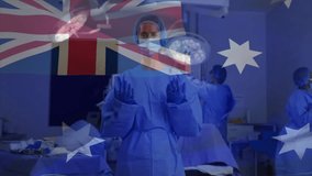 Surgical team preparing surgery while Australian flag graphic fading in over lights and instruments. Medical, teamwork, sterile, clinical, precision, resilience, professional - Powered by Shutterstock - Get 15% off with code: PIKWIZARD15