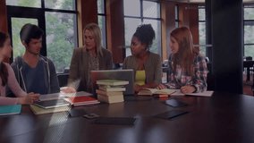 Facilitator resting hands on laptop and textbooks in library guiding group assignment discussion. Collaboration, teamwork, education, learning, brainstorming, professional, modern - Powered by Shutterstock - Get 15% off with code: PIKWIZARD15