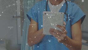 Medical professional tapping tablet in clinic activating animated data network, wearing stethoscope. Technician, healthcare, digital, technology, connectivity, patient, professionalism - Powered by Shutterstock - Get 15% off with code: PIKWIZARD15