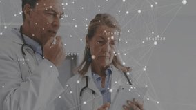 Female physician tapping tablet and male physician pointing data overlay while reviewing records. Professional, collaboration, digital, healthcare, technology, science, analytics - Powered by Shutterstock - Get 15% off with code: PIKWIZARD15