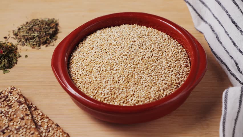 White quinoa, close-up. Quinoa seeds are rich in protein, vitamins and minerals. Healthy nutrition, vegan food. High quality 4k footage