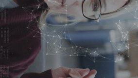 Adjusting glasses, woman interacting with animation on transparent screen in school. Technology, innovation, education, interaction, digital, futuristic - Powered by Shutterstock - Get 15% off with code: PIKWIZARD15