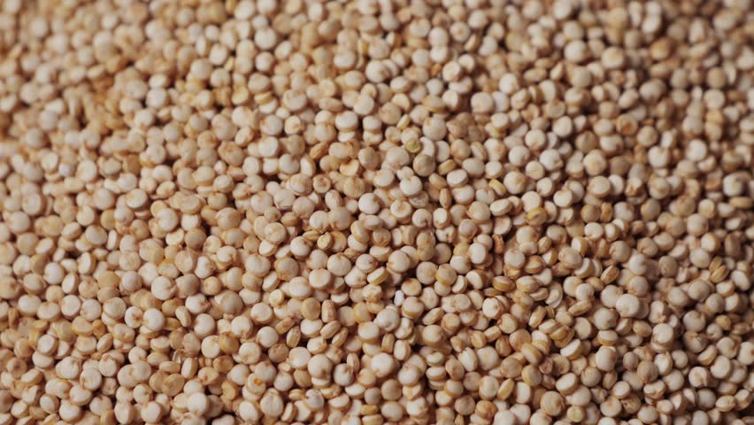 White quinoa, close-up. Quinoa seeds are rich in protein, vitamins and minerals. Healthy nutrition, vegan food. High quality 4k footage