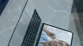 On laptop, man video calling with digital network animation overlay in office. Technology, communication, business, connection, virtual, telecommuting - Powered by Shutterstock - Get 15% off with code: PIKWIZARD15