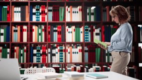 Female Professor Studying In University Library With Book - Powered by Shutterstock - Get 15% off with code: PIKWIZARD15