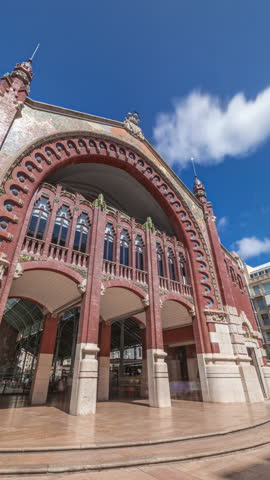 Mercado de Colon facade timelapse hyperlapse in Valencia, Spain, showcasing stunning Art Nouveau architecture. Popular tourist attraction with shops and cafes in a beautifully restored market building