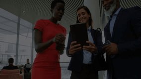 Three colleagues gathering around tablet and initiating animated business graphs revealing metrics. Corporate, teamwork, analytics, data visualization, modern, professional, collaboration - Powered by Shutterstock - Get 15% off with code: PIKWIZARD15