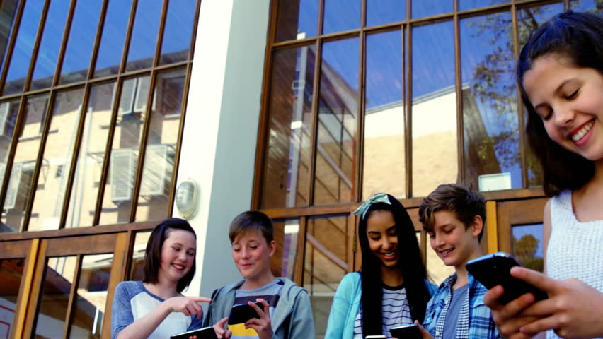 five youths tapping devices at glass doors, initiating social media icons showing on smartphones. Teenagers, technology, social media, connectivity, youth culture, digital interaction, urban - Powered by Shutterstock - Get 15% off with code: PIKWIZARD15