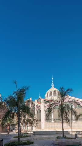 Panorama showing Valencia Central Market timelapse. Historic public market with stunning architecture, stained glass, dome and tile details. Located in Market Square near Santos Juanes Church. Spain
