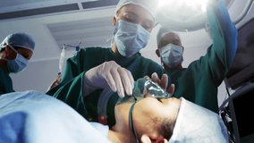 Surgeon securing mask starting green hologram for visibility while team raising light, checking IV. Medical, surgical, operating room, healthcare, teamwork, technology, sterile - Powered by Shutterstock - Get 15% off with code: PIKWIZARD15