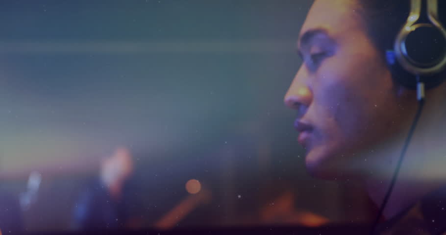 Sound engineer opening eyes mouthing lyrics in studio on song starting with light streaks drifting. Studio, music, ambient, focus, technology, creative, recording