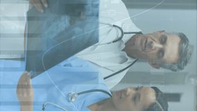 Animation of data processing over diverse doctors with x ray. Global medicine, connections, computing and data processing concept digitally generated video - Powered by Shutterstock - Get 15% off with code: PIKWIZARD15