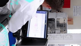 Animation of scientific data processing over caucasian male scientist with computer in laboratory. Global science, research, computing and data processing concept digitally generated video. - Powered by Shutterstock - Get 15% off with code: PIKWIZARD15