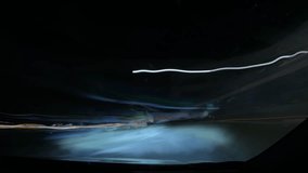 Long exposure shot from inside a moving vehicle showing light trails and dashboard during night drive. - Powered by Shutterstock - Get 15% off with code: PIKWIZARD15
