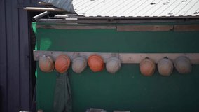 Row of safety helmets neatly hung on hooks. Engineering and construction workers’ protective equipment during lunch break or after the working day. Symbol of rest and safety at the job site. - Powered by Shutterstock - Get 15% off with code: PIKWIZARD15
