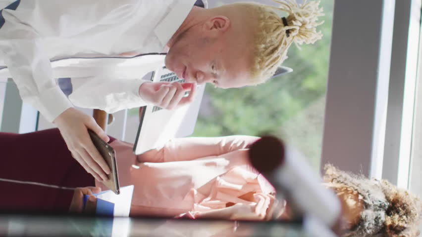 Animation of multiple notification bars over diverse coworkers discussing reports in office. Digital composite, multiple exposure, business, social media reminder, teamwork and technology concept. - Powered by Shutterstock - Get 15% off with code: PIKWIZARD15