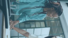 Animation of flowcharts over diverse female coworkers sharing ideas on blueprint and shaking hands. Digital composite, multiple exposure, communication, planning and teamwork concept. - Powered by Shutterstock - Get 15% off with code: PIKWIZARD15