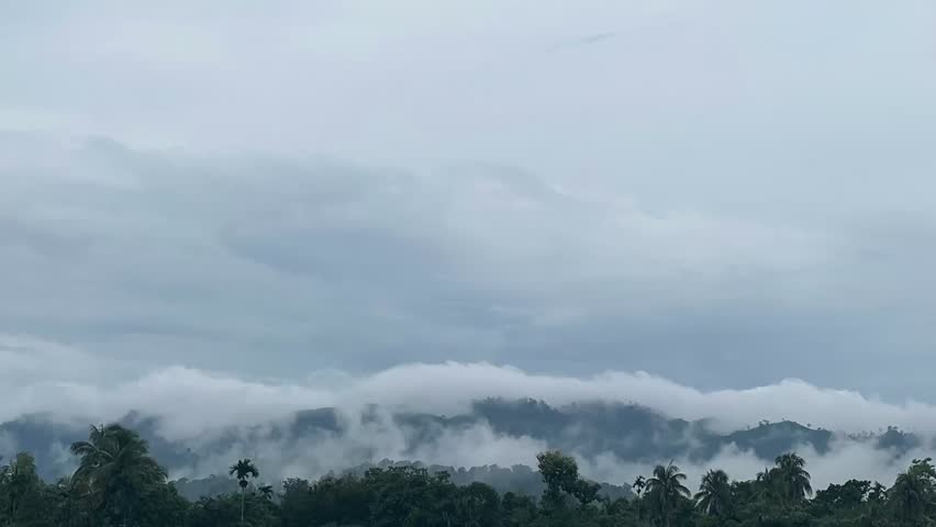 A captivating timelapse video showing clouds gracefully drifting over rolling hills. 