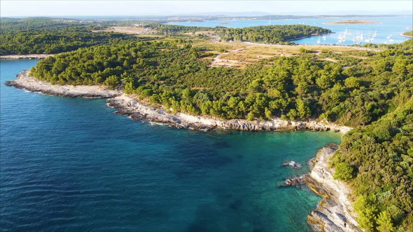 Aerial panorama of the rugged coastline of Radovica Beach, Park Pay, lighthouse, Bunker Kamenjak and the Debeljak Cove from the other side of the on the Premantura peninsula, Istria, Croatia. Summer.