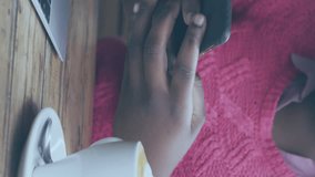 Animation of social media icons over african american woman with face mask using smartphone. Global covid 19 pandemic, social media, and digital interface concept digitally generated video. - Powered by Shutterstock - Get 15% off with code: PIKWIZARD15