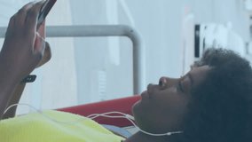 Animation of icons and data processing over african american woman using smartphone. Global social media, connections, computing and data processing concept digitally generated video. - Powered by Shutterstock - Get 15% off with code: PIKWIZARD15