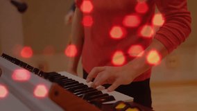 Male playing keyboard with red lights, camera panning, revealing her playing guitar in music duet. Performance, collaboration, harmony, improvisation, concert, textured, vibrant - Powered by Shutterstock - Get 15% off with code: PIKWIZARD15