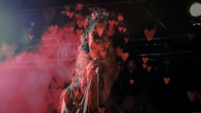 Female vocalist gripping mic and singing on stage with floating hearts and smoke to evoke emotion. Concert, performance, emotion, passion, nightlife, rock, stagecraft - Powered by Shutterstock - Get 15% off with code: PIKWIZARD15
