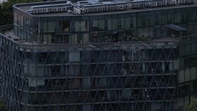 Close-up of a contemporary glass high-rise featuring a diamond-patterned structural facade, private balconies, and rooftop HVAC systems. - Powered by Shutterstock - Get 15% off with code: PIKWIZARD15