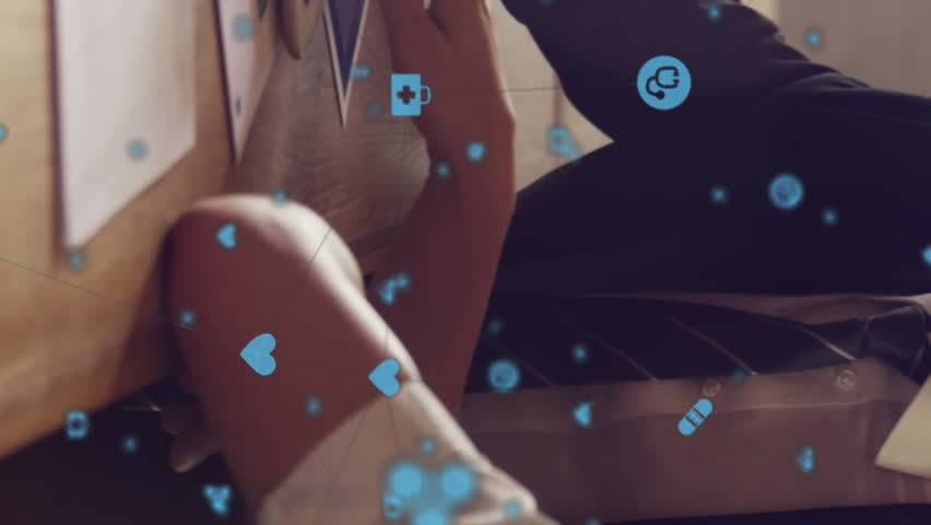 Animation of a network of icons connecting over man and woman sitting in office using tablet computer and talking. Global digital network digitally generated image. - Powered by Shutterstock - Get 15% off with code: PIKWIZARD15