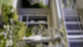 Animation of golden house keys and house shaped key fob hanging over an out of focus house 4k - Powered by Shutterstock - Get 15% off with code: PIKWIZARD15