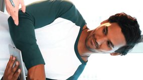 Animation of multiple face emojis floating over male and female office colleagues talking over digital tablet. Global online social media network digital interface concept digitally generated image. - Powered by Shutterstock - Get 15% off with code: PIKWIZARD15