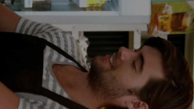 Animation of multiple graphs and trading board over caucasian baristas discussing and making coffee. Digital composite, multiple exposure, report, business, profession and stock market concept. - Powered by Shutterstock - Get 15% off with code: PIKWIZARD15