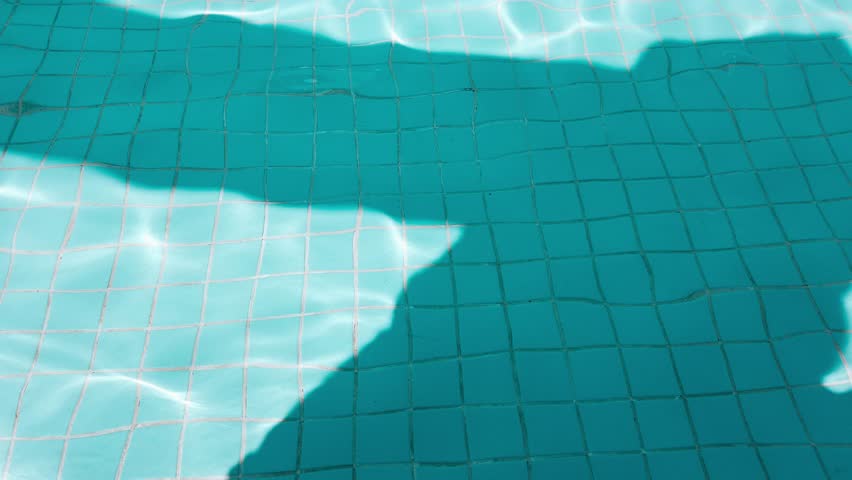 Swimming pool close-up and sun light reflection
