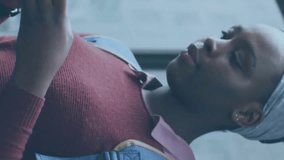 Animation of media icons over african american woman using smartphone. Social media, lifestyle and digital interface concept digitally generated video. - Powered by Shutterstock - Get 15% off with code: PIKWIZARD15