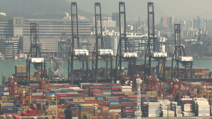HONG KONG, CHINA - AUGUST 2012: Cranes Moving To Unload Container Ship. Shot