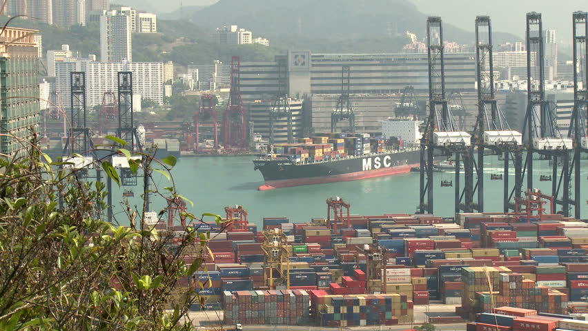 HONG KONG, CHINA - AUGUST 2012: Container Ship Maneuvering In Port Wide Shot.