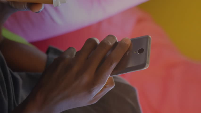 Man holding phone and drink with stock market data animation overlay. Finance, trading, technology, investment, economy, business - Powered by Shutterstock - Get 15% off with code: PIKWIZARD15