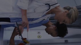 Animation of graphs and trading boards, diverse female doctor examining patient in hospital. Digital composite, multiple exposure, report, business, stock market, medical and healthcare concept. - Powered by Shutterstock - Get 15% off with code: PIKWIZARD15