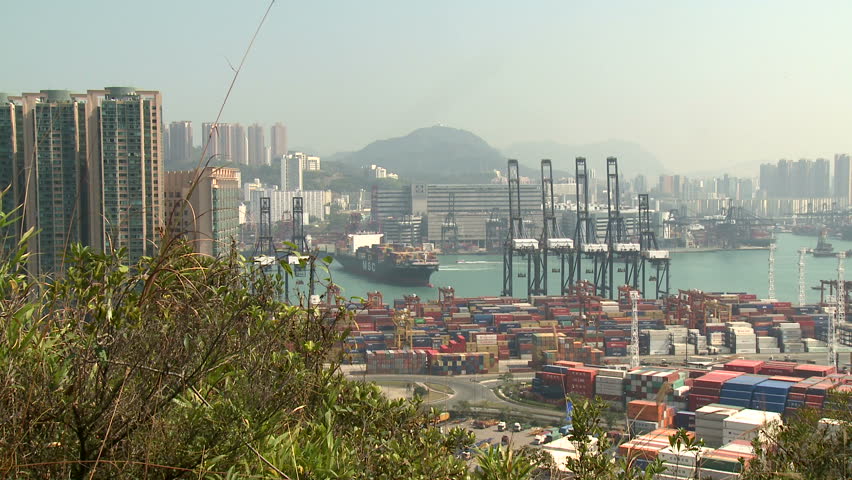 HONG KONG, CHINA - AUGUST 2012: Container Ship Maneuvering In Port Wide Shot.