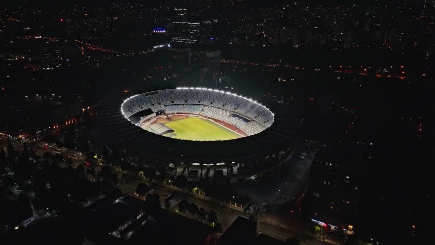 Football Stadium. Night panorama aerial view of Tbilisi, Georgia. Tourism landmark of city. Soccer field. Soccer stadium. Football stadium. Football field arena.
